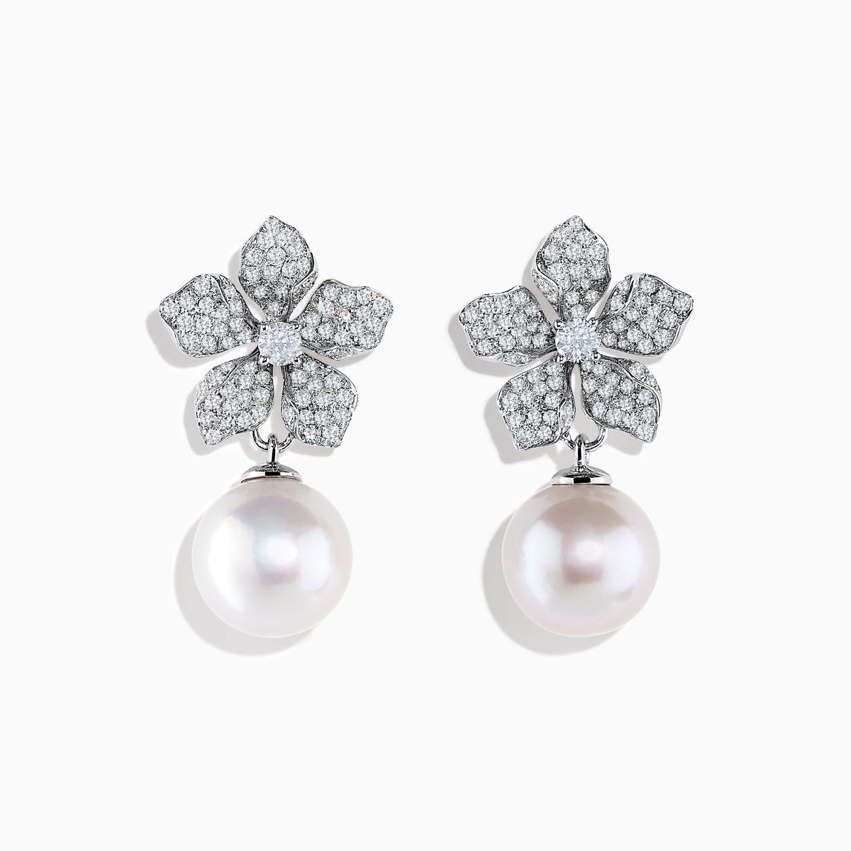 The 14K White Gold Diamond Flower and Fresh Water Pearl Drop Earrings feature diamond-studded flower tops with large round freshwater pearls dangling below, beautifully displayed against a white background.