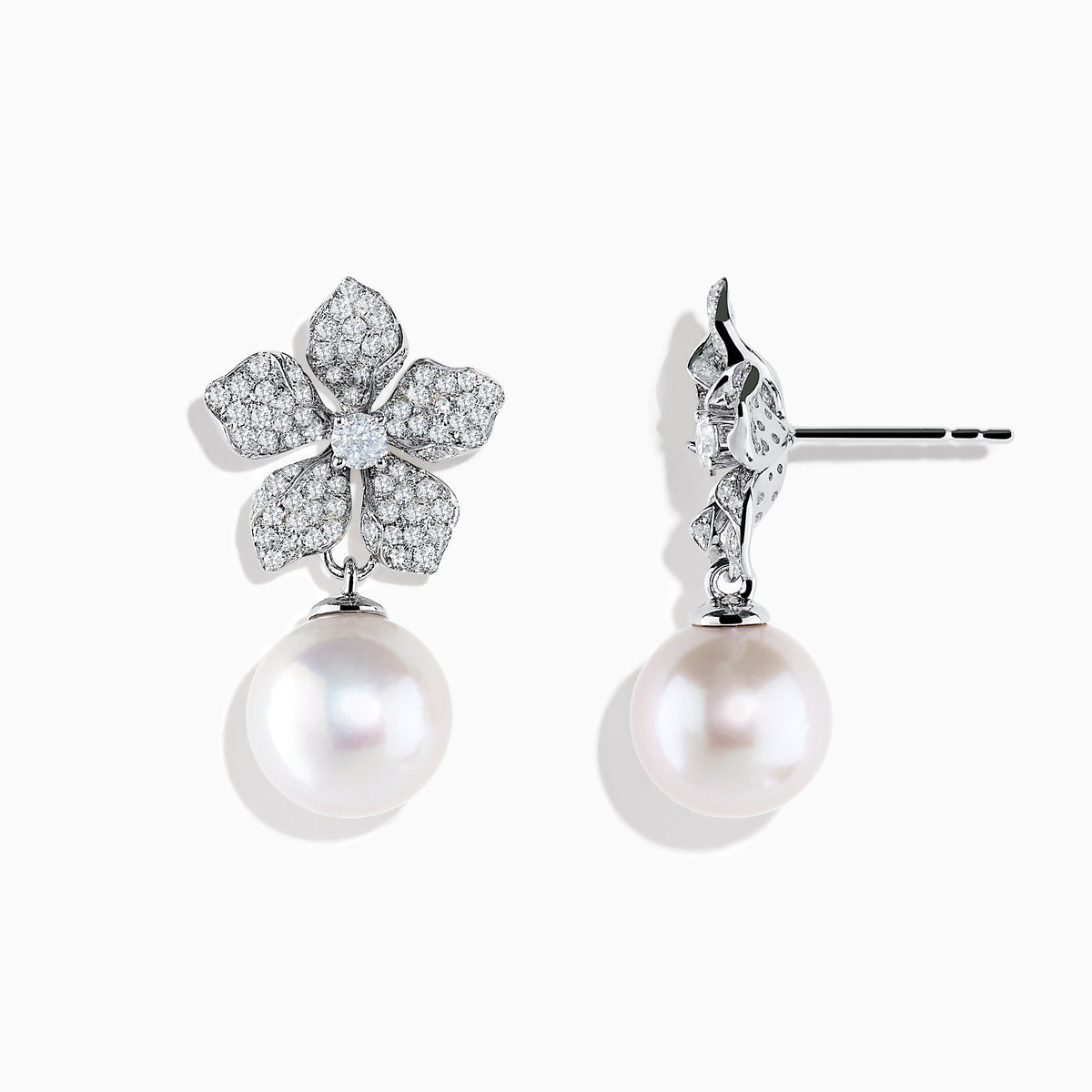 The 14K White Gold Diamond Flower and Fresh Water Pearl Drop Earrings feature diamond-studded flower tops with large round freshwater pearls dangling below, beautifully displayed against a white background.