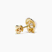A pair of 14K yellow gold scalloped edge stud earrings featuring a central freshwater pearl, accented with diamonds, set against a white background.