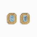 The 14K Yellow Gold Aquamarine and Diamond Double Halo Earrings feature emerald-cut light blue gemstones framed by rectangular diamond double halos.