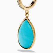 The 14K Yellow Gold Turquoise and Diamond Drop Earrings feature teardrop turquoise stones and sparkling diamonds along the hooks, shown on a white background.