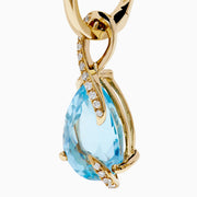 Ocean Bleu 14K Yellow Gold Blue Topaz and Diamond Pear Dangle Earrings feature teardrop-shaped blue topaz gemstones accented with a curved line of sparkling diamonds.