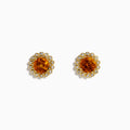 The 14K Yellow Gold Citrine and Diamond Halo Stud Earrings feature round orange citrine centers encircled by a halo of sparkling diamonds, all set in yellow gold.