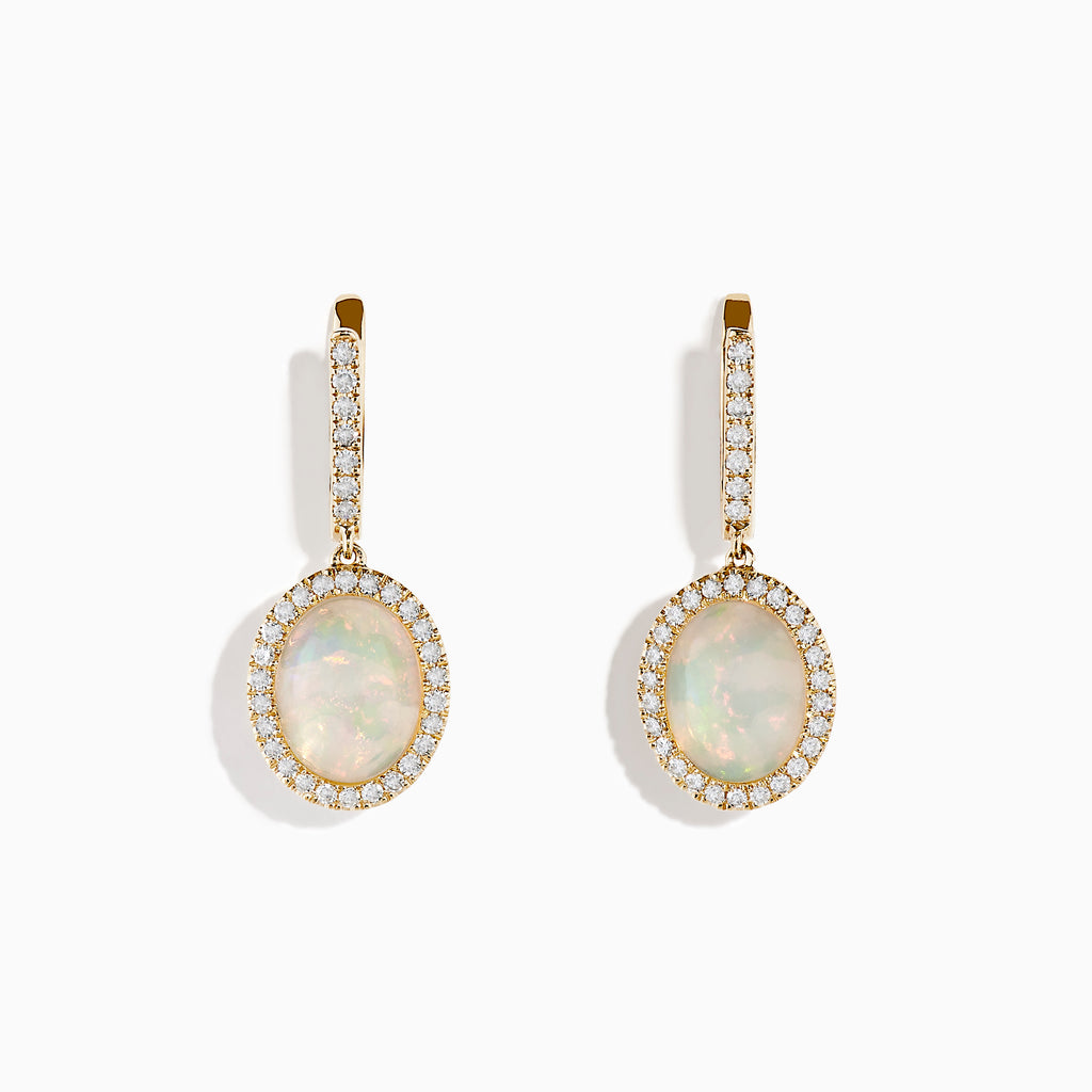 The 14K Yellow Gold Opal and Diamond Drop Earrings feature oval opal gemstones framed by sparkling diamonds, with additional diamond accents on the gold hoops and drops, creating an elegant look against a white background.