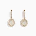 The 14K Yellow Gold Opal and Diamond Drop Earrings feature oval opal gemstones framed by sparkling diamonds, with additional diamond accents on the gold hoops and drops, creating an elegant look against a white background.