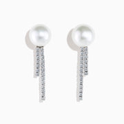 The 14K White Gold Cultured Pearl and Diamond Drop Earrings feature round cultured pearls atop two vertical rows of sparkling diamonds, all set against a plain white background.
