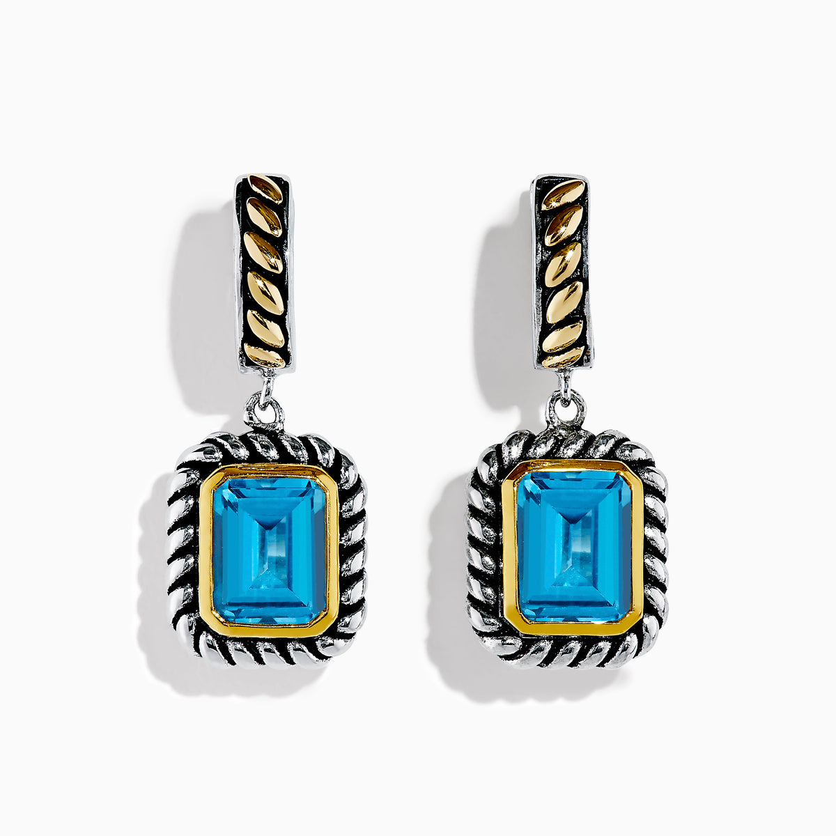 The Ocean Bleu 925 Sterling Silver and 18K Yellow Gold Blue Topaz Earrings feature rectangular gemstones in a twisted rope design with gold-accented posts, shown against a white background.