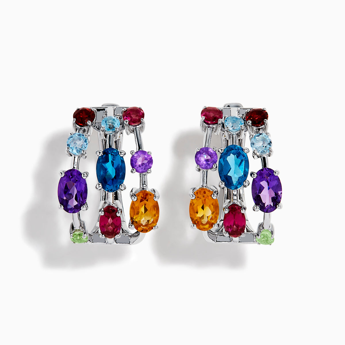 The Mosaic 925 Sterling Silver Multi Colored Gem Hoop Earrings feature three rows of vibrant blue, purple, red, orange, and green gemstones on each hoop, set against a white background.