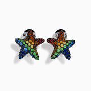 The Seaside 925 Sterling Silver Multi Color Sapphire Starfish Earrings feature star-shaped studs encrusted with sapphire gemstones in blue, green, orange, red, and yellow set in dark metal.