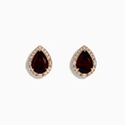 A pair of 14K Rose Gold Garnet and Diamond Earrings featuring teardrop-shaped deep red gemstones encircled by sparkling white diamonds, beautifully displayed on a white background.
