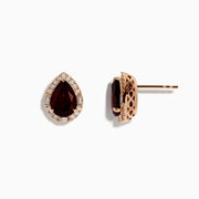 A pair of 14K Rose Gold Garnet and Diamond Earrings featuring teardrop-shaped deep red gemstones encircled by sparkling white diamonds, beautifully displayed on a white background.