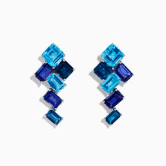 The 14K White Gold Blue Topaz and Iolite Earrings feature square and rectangular blue gemstones arranged diagonally, creating a striking and elegant accessory.