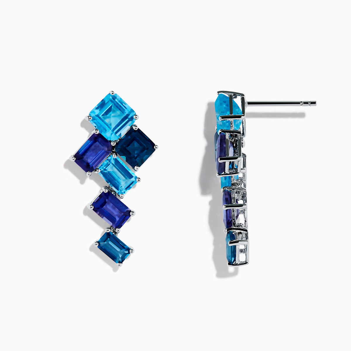 The 14K White Gold Blue Topaz and Iolite Earrings feature square and rectangular blue gemstones arranged diagonally, creating a striking and elegant accessory.