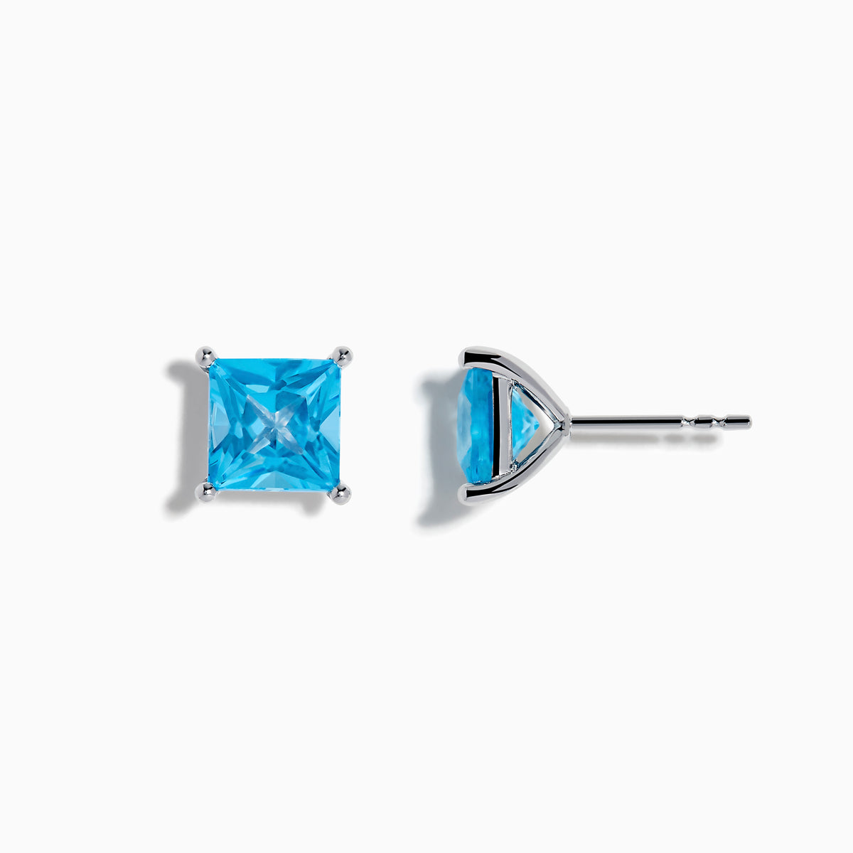 The Ocean Bleu 14K White Gold Blue Topaz Stud Earrings feature square-cut blue topaz in four-prong settings, displayed on a white background.