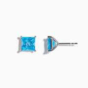 The Ocean Bleu 14K White Gold Blue Topaz Stud Earrings feature square-cut blue topaz in four-prong settings, displayed on a white background.