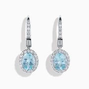 14K White Gold Aquamarine and Diamond Dangle Earrings feature oval aquamarines encircled by sparkling diamonds, with additional diamonds on the hooks—an elegant choice for any occasion.