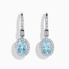 14K White Gold Aquamarine and Diamond Dangle Earrings feature oval aquamarines encircled by sparkling diamonds, with additional diamonds on the hooks—an elegant choice for any occasion.