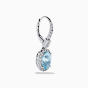 14K White Gold Aquamarine and Diamond Dangle Earrings feature oval aquamarines encircled by sparkling diamonds, with additional diamonds on the hooks—an elegant choice for any occasion.