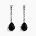A pair of 14K White Gold Black Onyx and Diamond Linear Drop Earrings featuring alternating diamonds and black onyx gemstones, ending with a large faceted teardrop-shaped black onyx for a timeless look.