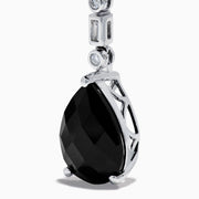 A pair of 14K White Gold Black Onyx and Diamond Linear Drop Earrings featuring alternating diamonds and black onyx gemstones, ending with a large faceted teardrop-shaped black onyx for a timeless look.