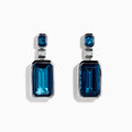 14K White Gold Blue Topaz and Diamond Geometric Drop Earrings featuring rectangular deep blue topaz gems, each accented by a smaller blue stone and a baguette-cut diamond, displayed against a white background.