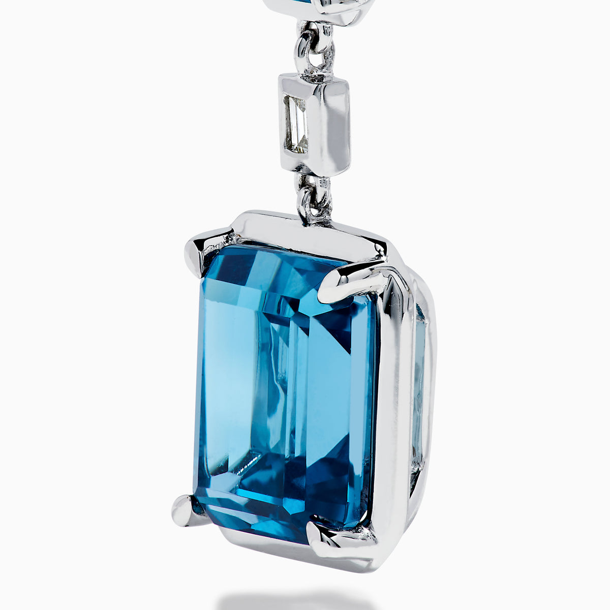 14K White Gold Blue Topaz and Diamond Linear Drop Earrings featuring three rectangular blue topaz gems and two small vertical diamonds in an alternating, linear pattern.
