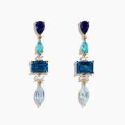 The 14K Yellow Gold Diamond Blue Topaz, Iolite and Apatite Earrings feature blue gemstones in teardrop, rectangular, and marquise shapes, arranged vertically for a colorful and elegant design.