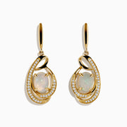 Introducing the Aurora 14K Yellow Gold Opal and Diamond Earrings, featuring oval opals encircled by sparkling diamonds and finished with a graceful swirl design.