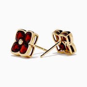 14K Yellow Gold Garnet and Diamond Earrings featuring four-petaled flower studs with deep red garnet petals and a small diamond center, shown on a white background.