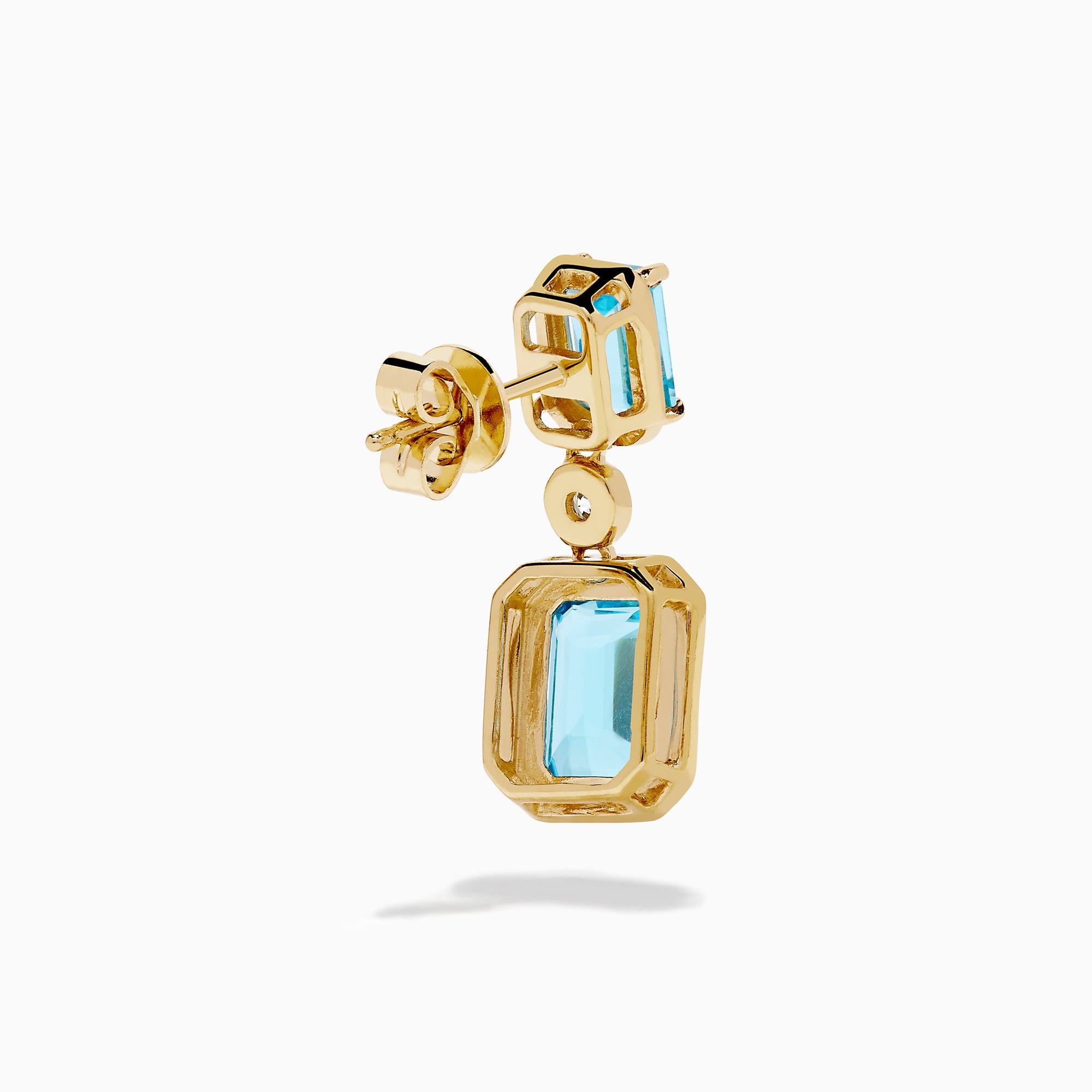 Elegant and symmetrical, the 14K Yellow Gold Blue Topaz and Diamond Drop Earrings display rectangular blue topaz stones with smaller gems above, separated by a sparkling diamond drop, set against a white background.