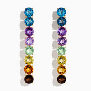 The Mosaic 14K Yellow Gold Multi Semi Precious Gemstone Linear Drop Earrings showcase a vertical row of gems in a blue-to-brown rainbow gradient, creating an eye-catching look.