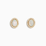 The Aurora 14K Yellow Gold Opal and Diamond Stud Earrings feature oval opals encircled by a halo of sparkling diamonds, set in yellow gold and shown against a white background.