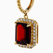 The Bordeaux 14K Yellow Gold Garnet and Diamond Earrings feature large rectangular deep red garnets surrounded by a border of sparkling diamonds, elegantly displayed against a white background.