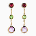 The 14K Yellow Gold Diamond and Multi Color Gemstone Linear Drop Earrings feature red, green, and a larger purple gemstone with sparkling diamond accents, making these gold drop earrings a dazzling statement piece.