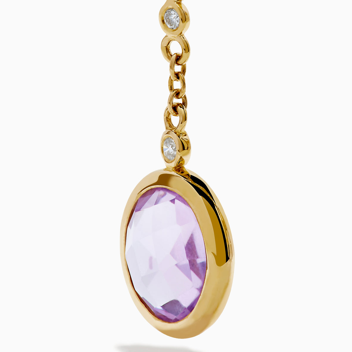 The 14K Yellow Gold Diamond and Multi Color Gemstone Linear Drop Earrings feature red, green, and a larger purple gemstone with sparkling diamond accents, making these gold drop earrings a dazzling statement piece.