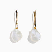 The 14K Yellow Gold Fresh Water Keshi Pearl Drop Earrings feature large, irregular Keshi pearls suspended from simple gold hooks, shown against a plain white background.