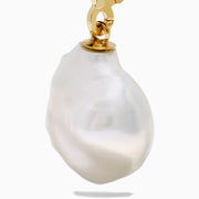 The 14K Yellow Gold Fresh Water Keshi Pearl Drop Earrings feature large, irregular Keshi pearls suspended from simple gold hooks, shown against a plain white background.