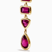 The 14K Yellow Gold Rhodolite Garnet Linear Drop Earrings feature five rhodolite garnets each in teardrop, triangle, and rectangle shapes, arranged vertically. Shown on a white background.