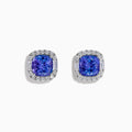 The Effy Hematian 18K White Gold Tanzanite and Diamond Cushion Halo Stud Earrings feature vibrant deep blue cushion-cut tanzanites, each encircled by a halo of sparkling white diamonds.