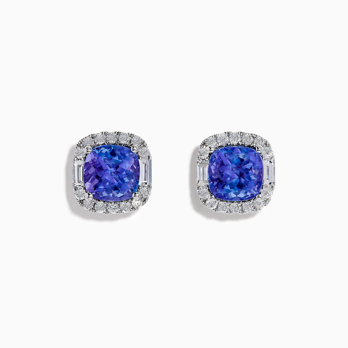 The Effy Hematian 18K White Gold Tanzanite and Diamond Cushion Halo Stud Earrings feature vibrant deep blue cushion-cut tanzanites, each encircled by a halo of sparkling white diamonds.