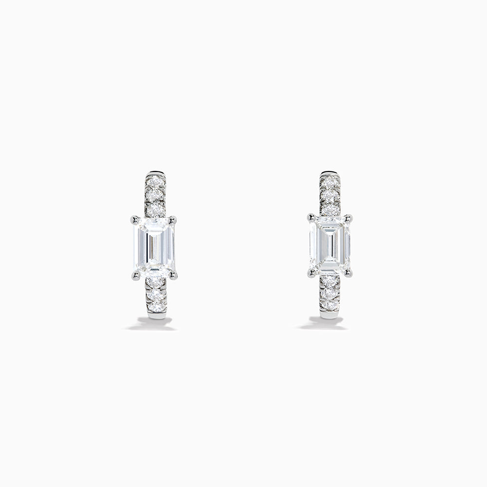 Lab Grown Diamond Emerald-Cut Huggie Earrings in 14K White Gold showcase rectangular center stones accented by small round diamonds, elegantly set and displayed against a plain white background.