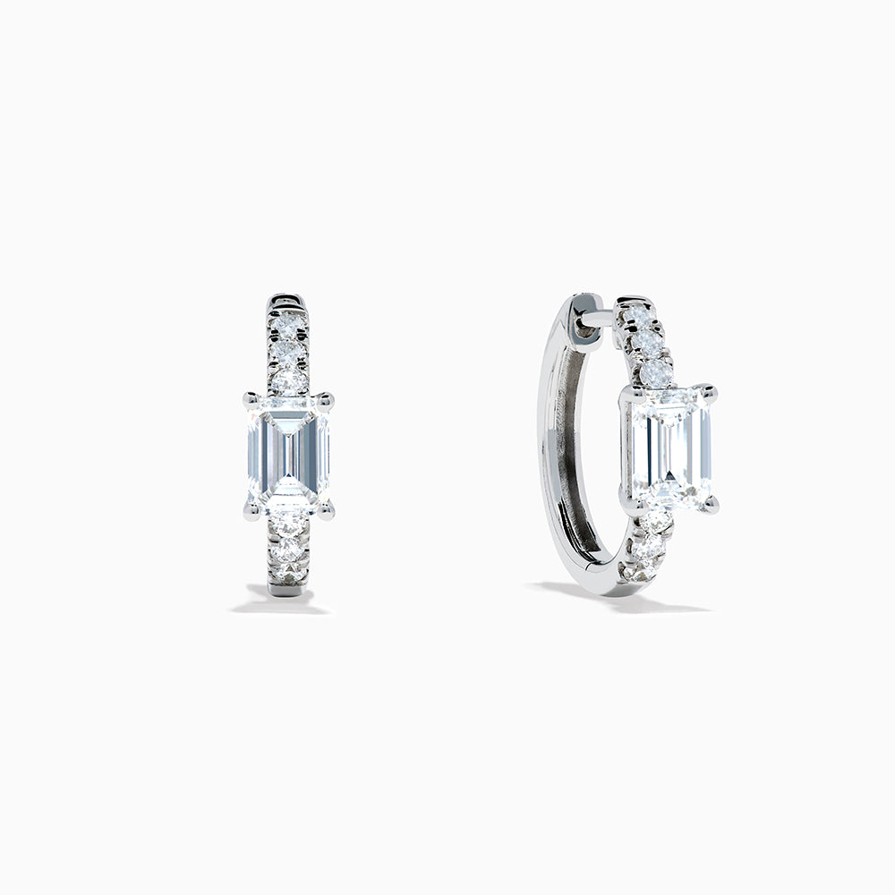 Lab Grown Diamond Emerald-Cut Huggie Earrings in 14K White Gold showcase rectangular center stones accented by small round diamonds, elegantly set and displayed against a plain white background.