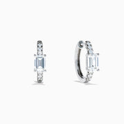 Lab Grown Diamond Emerald-Cut Huggie Earrings in 14K White Gold showcase rectangular center stones accented by small round diamonds, elegantly set and displayed against a plain white background.