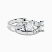 Lab Grown Diamond Emerald-Cut Huggie Earrings in 14K White Gold showcase rectangular center stones accented by small round diamonds, elegantly set and displayed against a plain white background.