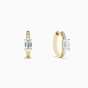 Lab Grown Diamond Emerald-Cut Huggie Earrings in 14K Yellow Gold, each with a central rectangular lab diamond and small round diamonds on the hoop, shown on a white background.