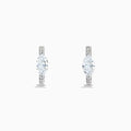 A pair of Lab Grown Diamond Marquise Huggie Earrings in 14K white gold, featuring dazzling lab-created gemstones, elegantly displayed on a plain white background.