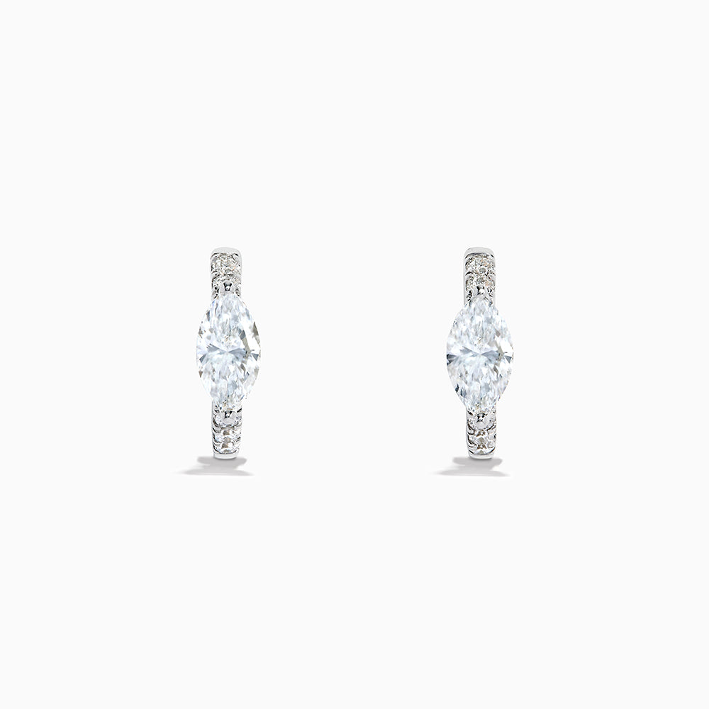 A pair of Lab Grown Diamond Marquise Huggie Earrings in 14K white gold, featuring dazzling lab-created gemstones, elegantly displayed on a plain white background.