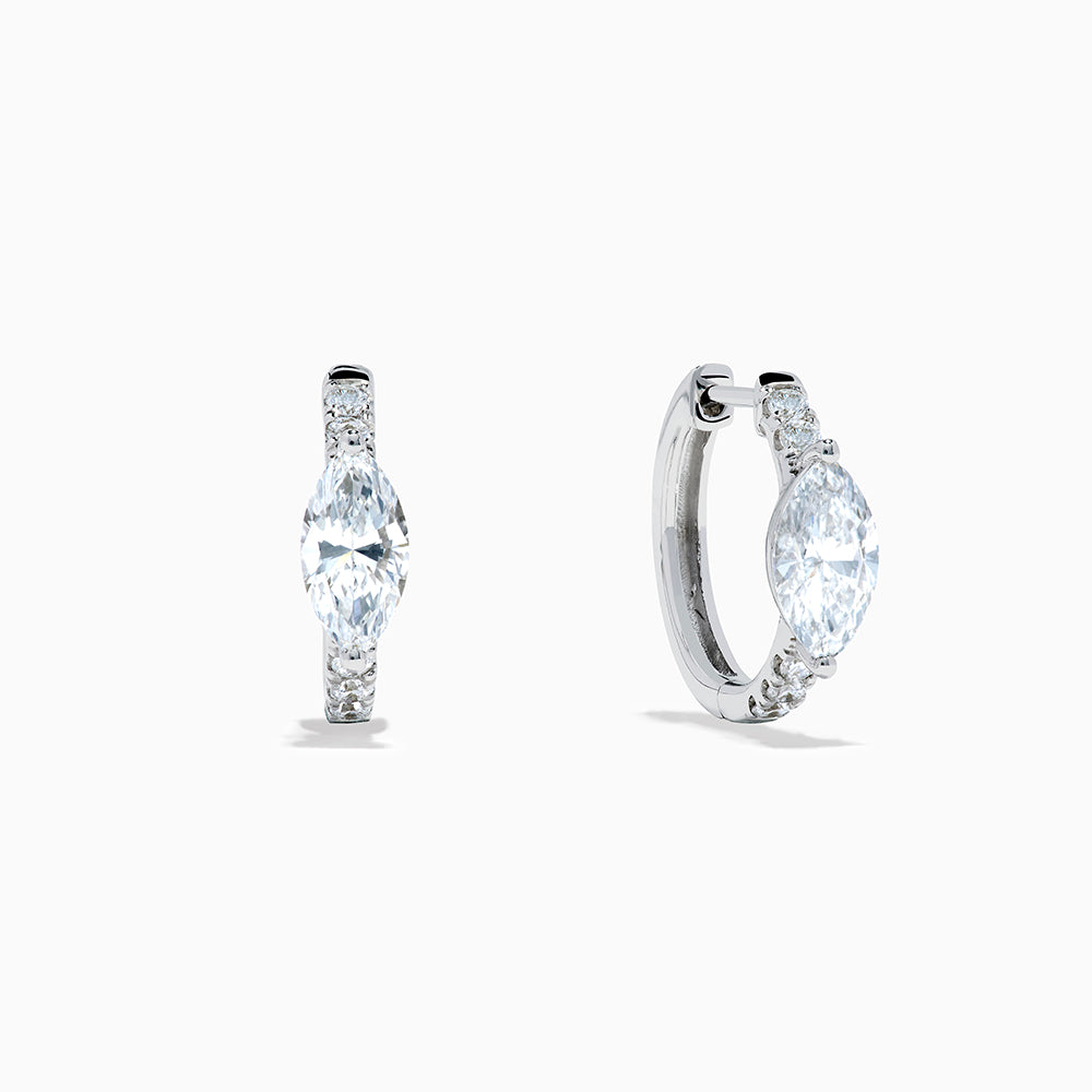 A pair of Lab Grown Diamond Marquise Huggie Earrings in 14K white gold, featuring dazzling lab-created gemstones, elegantly displayed on a plain white background.