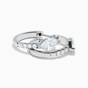 A pair of Lab Grown Diamond Marquise Huggie Earrings in 14K white gold, featuring dazzling lab-created gemstones, elegantly displayed on a plain white background.