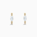 Lab Grown Diamond Marquise Huggie Earrings in 14K Yellow Gold, each showcasing a central round diamond and smaller accent diamonds along the vertical sides, displayed on a plain white background.